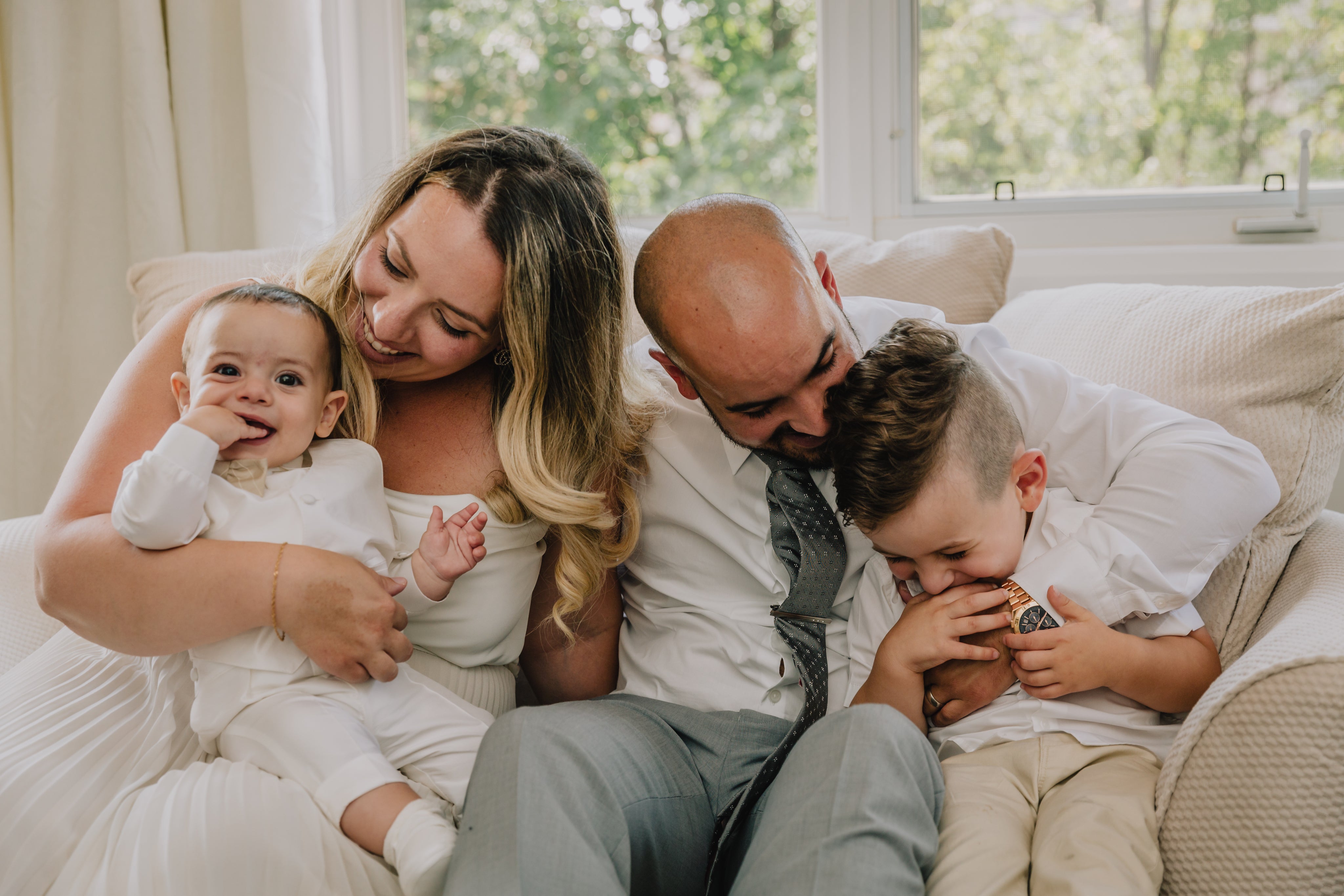 files/a-young-family-sitting-together-on-a-beige-couch.jpg